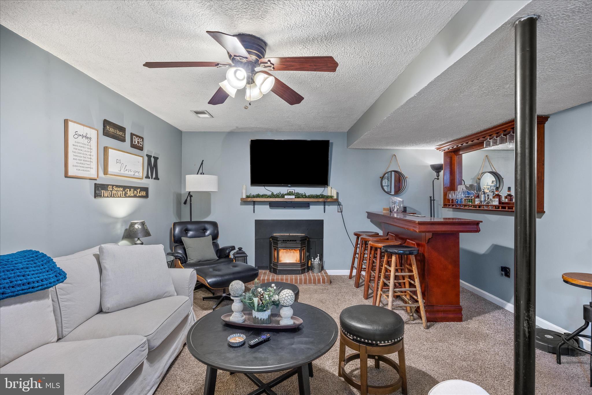 7914 Leeds Drive Pasadena, MD 21122 - Photo 32 of 49 a living room with furniture a fireplace and a flat screen tv