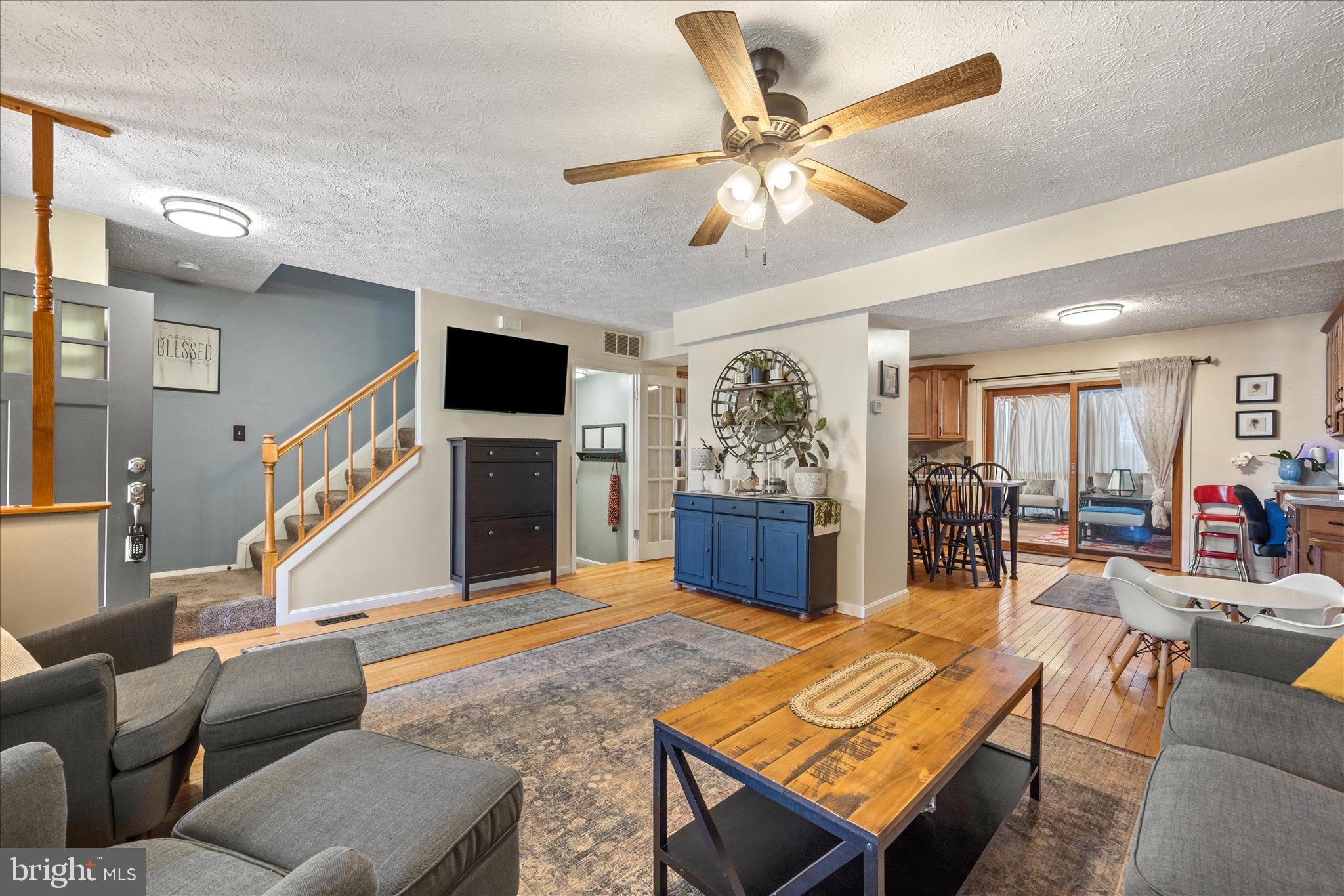 7914 Leeds Drive Pasadena, MD 21122 - Photo 4 of 49 a living room with furniture a fireplace and a flat screen tv