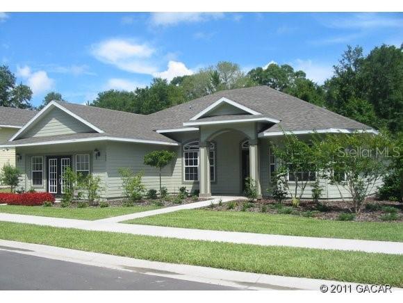 1657 Southwest 66th Drive Gainesville, FL 32607 - Photo 1 of 1 a front view of a house with a yard