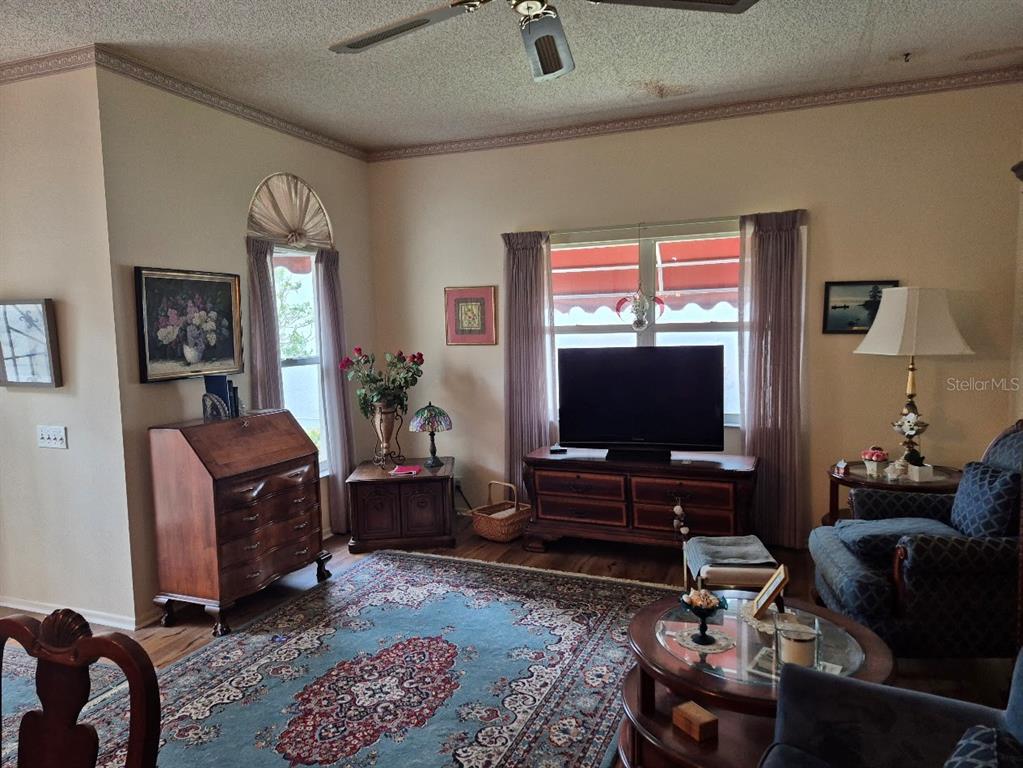 4903 Tamarack Trail Venice, FL 34293 - Photo 3 of 5 a living room with furniture and a flat screen tv