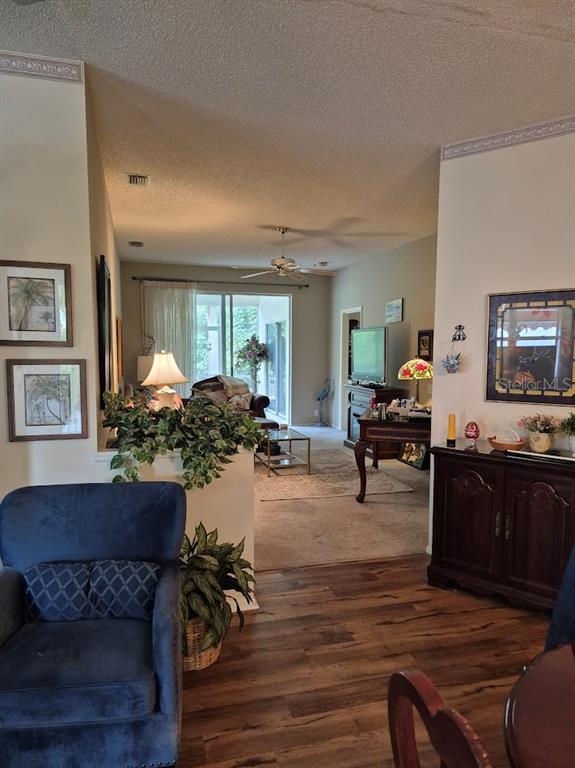 4903 Tamarack Trail Venice, FL 34293 - Photo 4 of 5 a living room with furniture and a flat screen tv