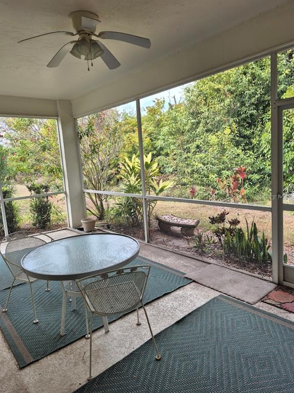 4903 Tamarack Trail Venice, FL 34293 - Photo 5 of 5 a living room with hardwood floor and a floor to ceiling window