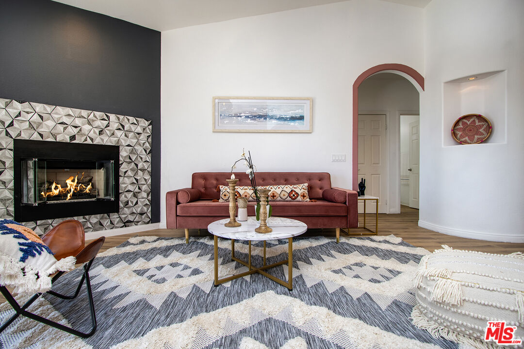 7285 Agave Road Joshua Tree, CA 92252 - Photo 2 of 18 a living room with furniture a rug and a fireplace