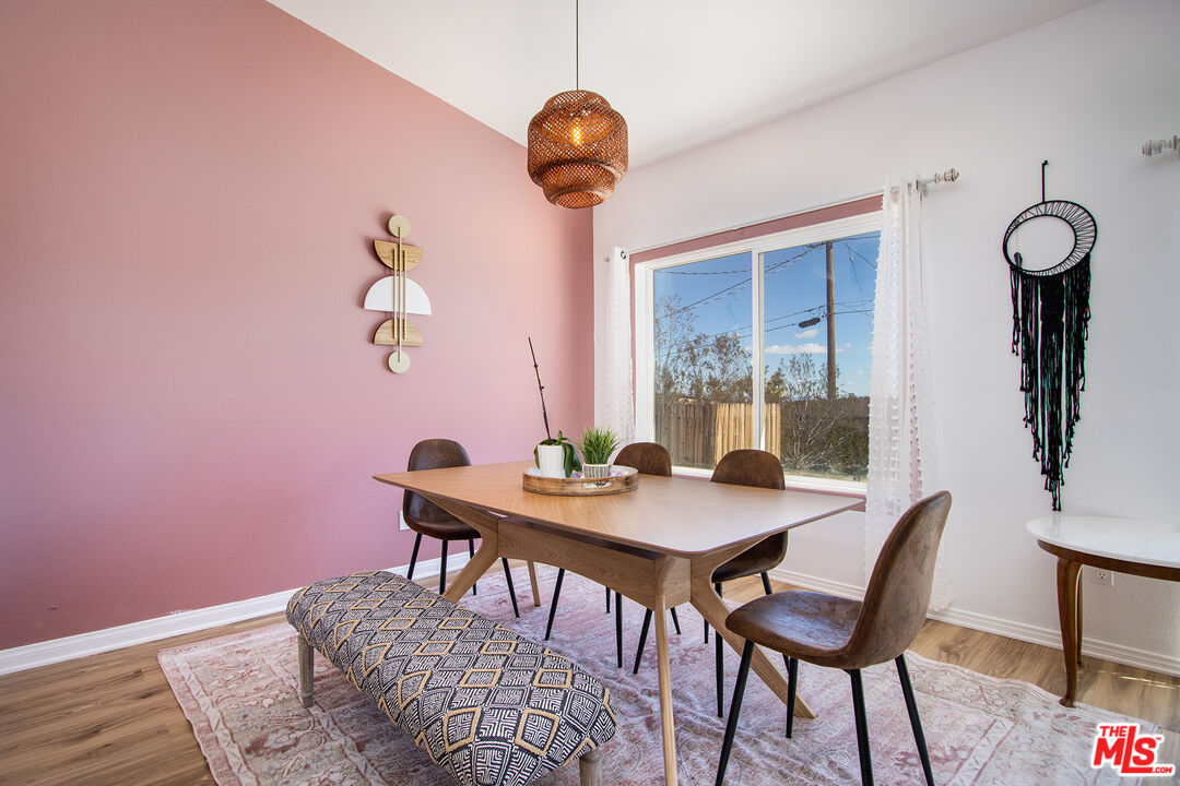 7285 Agave Road Joshua Tree, CA 92252 - Photo 3 of 18 a view of a dining room with furniture and wooden floor