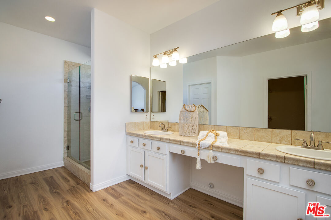 7285 Agave Road Joshua Tree, CA 92252 - Photo 9 of 18 a spacious bathroom with a double vanity sink and a mirror