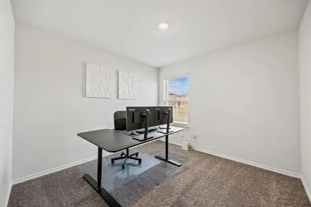 a view of a workspace with furniture