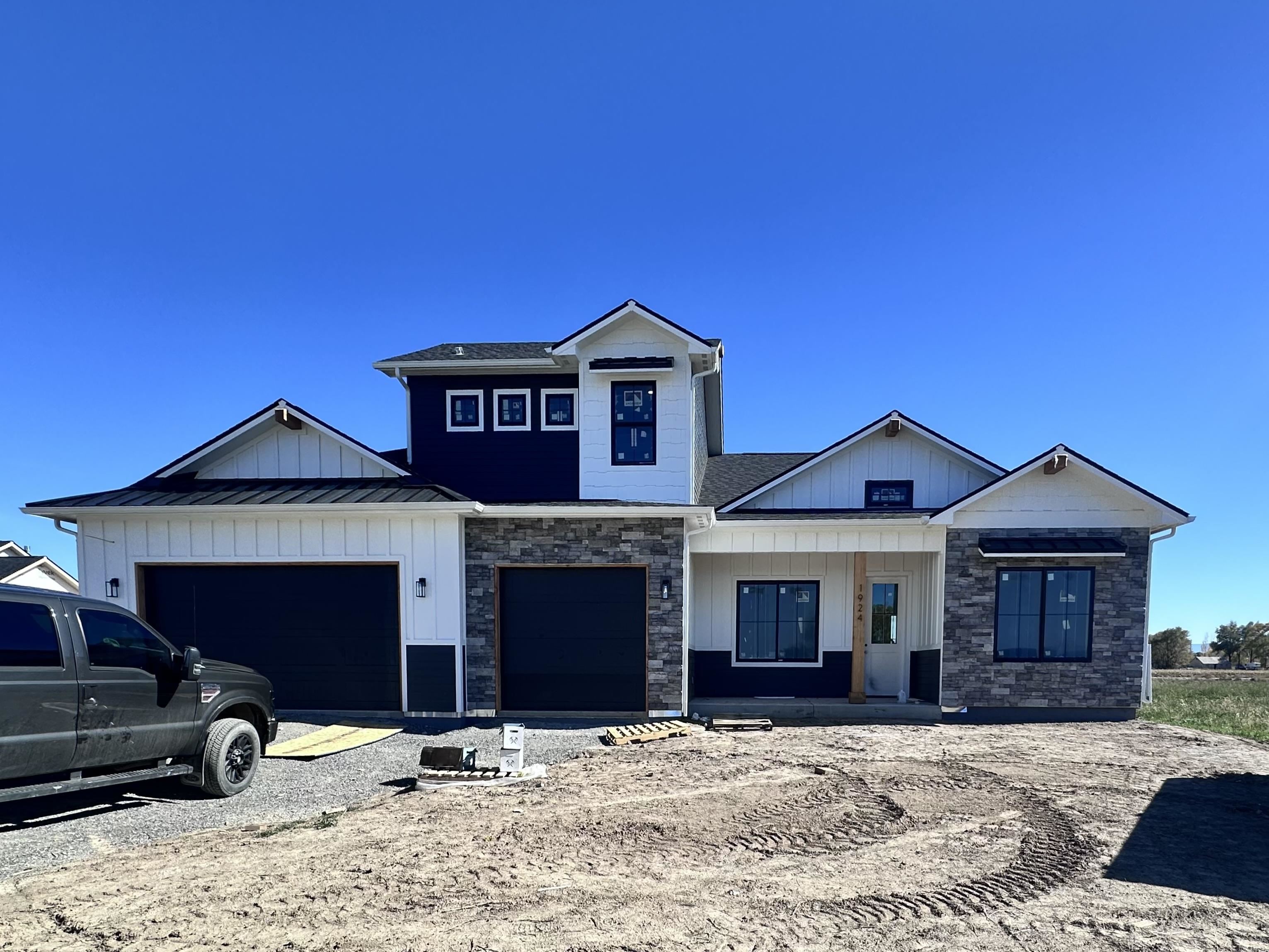 a front view of a house with yard and balcony