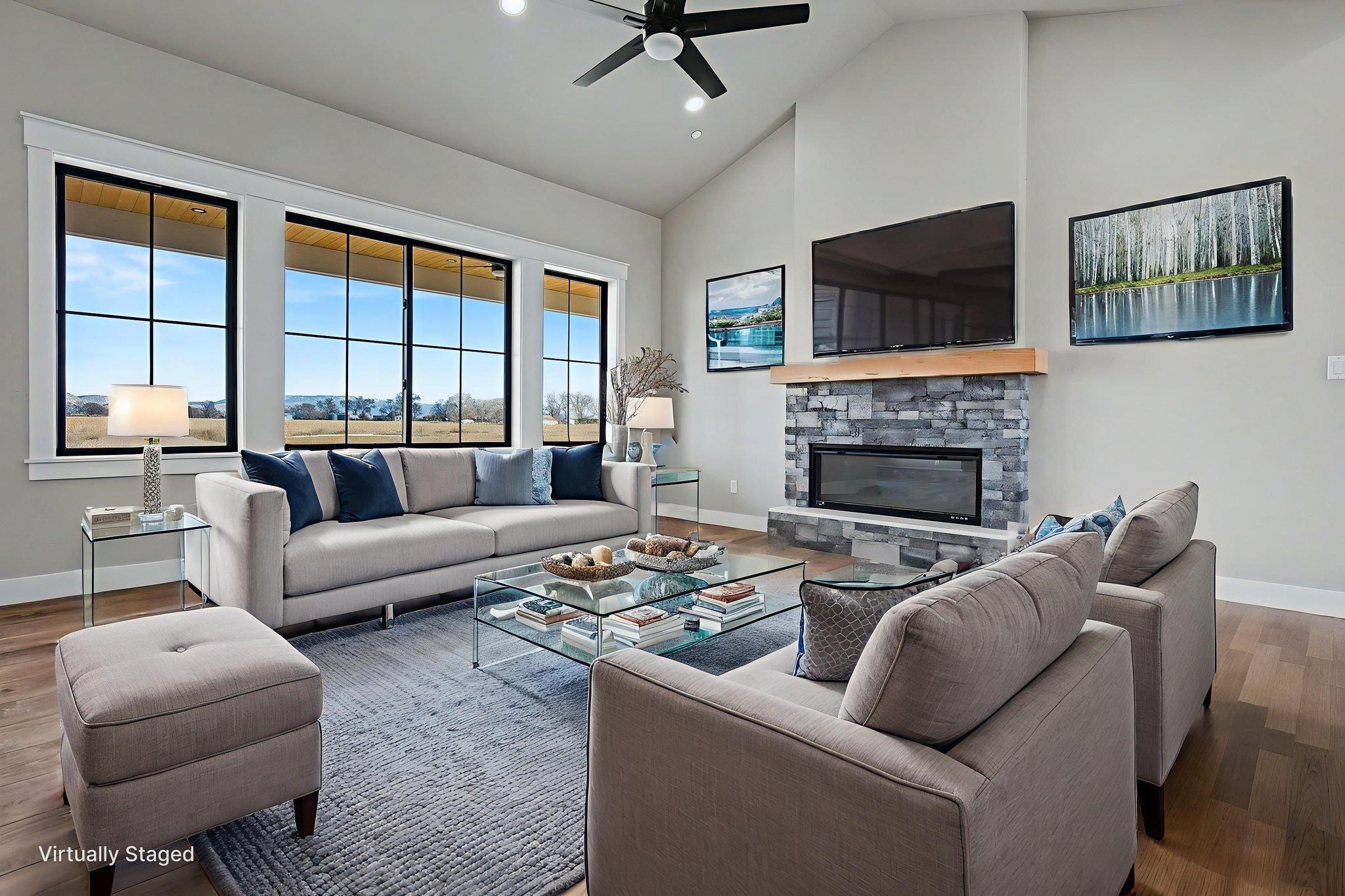 1924 K Road Fruita, CO 81521 - Photo 11 of 40 a living room with furniture a flat screen tv and a fireplace