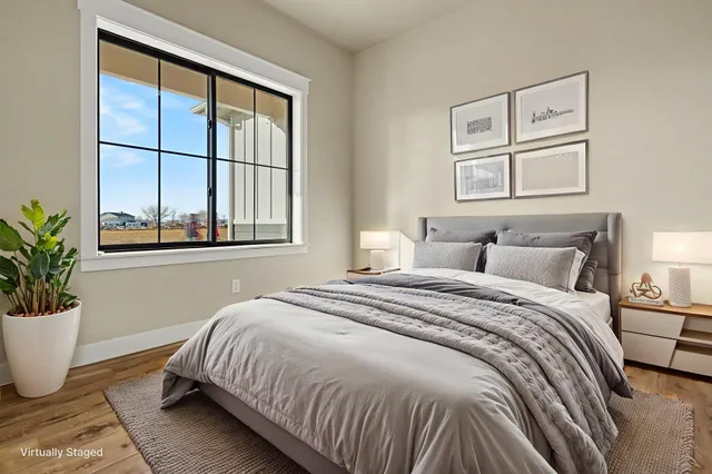 a bedroom with a large bed and a window