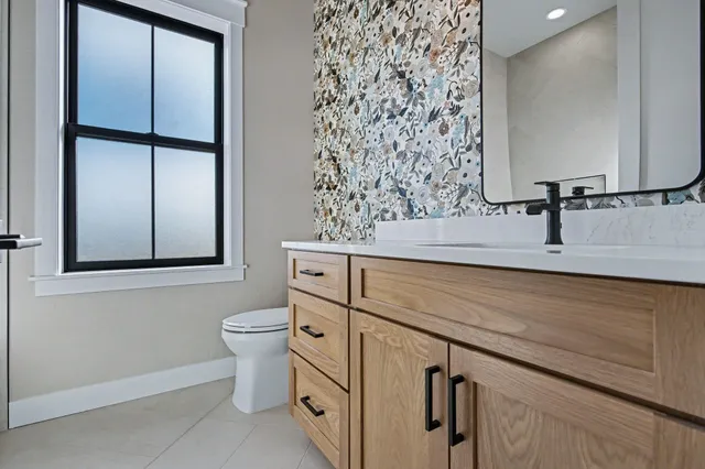 a bathroom with a sink toilet and mirror