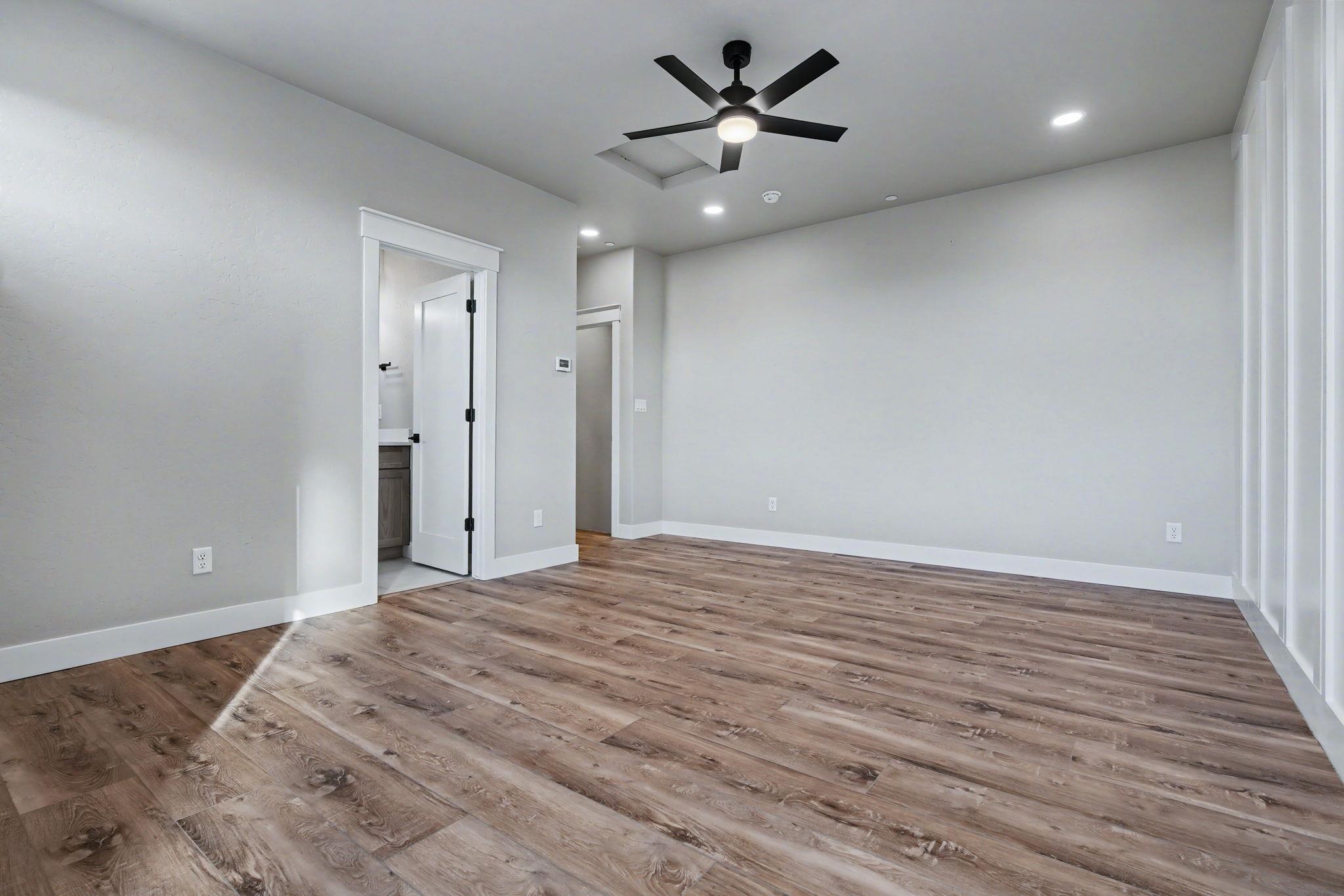 1924 K Road Fruita, CO 81521 - Photo 29 of 40 a view of a big room with wooden floor and a ceiling fan