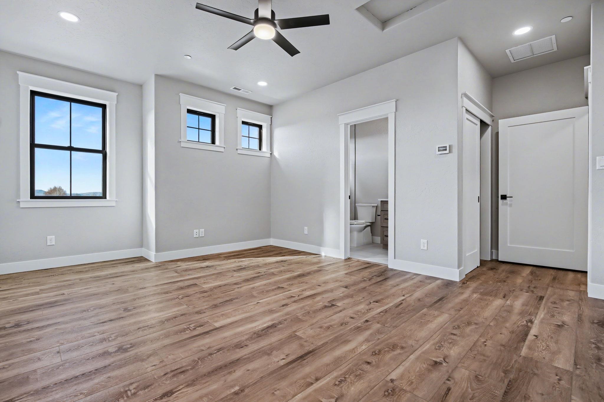 1924 K Road Fruita, CO 81521 - Photo 30 of 40 a view of an empty room with wooden floor and a window
