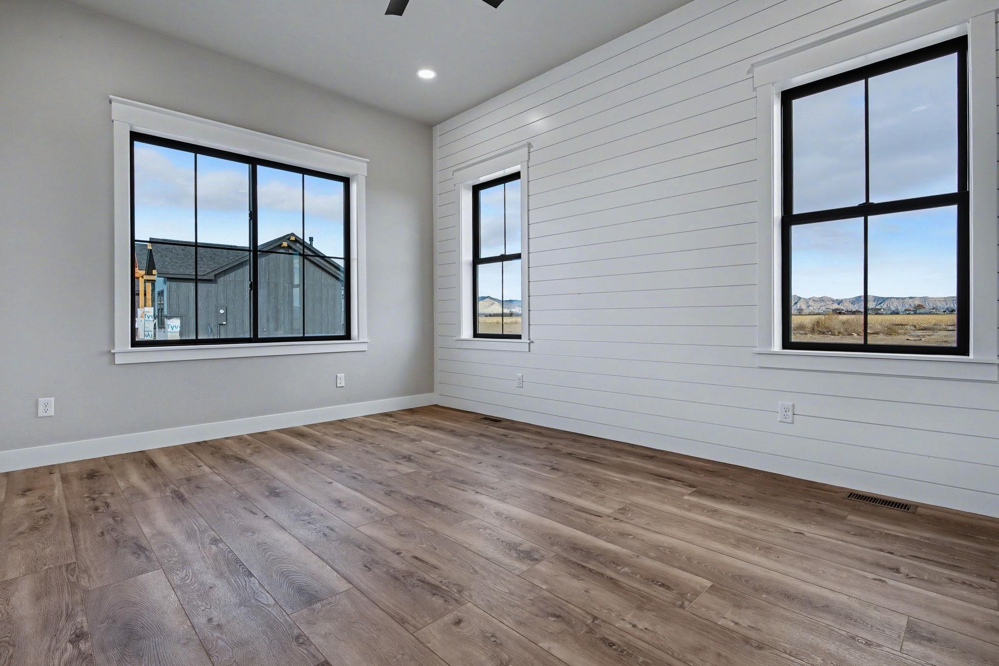 1924 K Road Fruita, CO 81521 - Photo 35 of 40 an empty room with wooden floor and windows