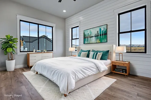 a bedroom with a large bed and a large window