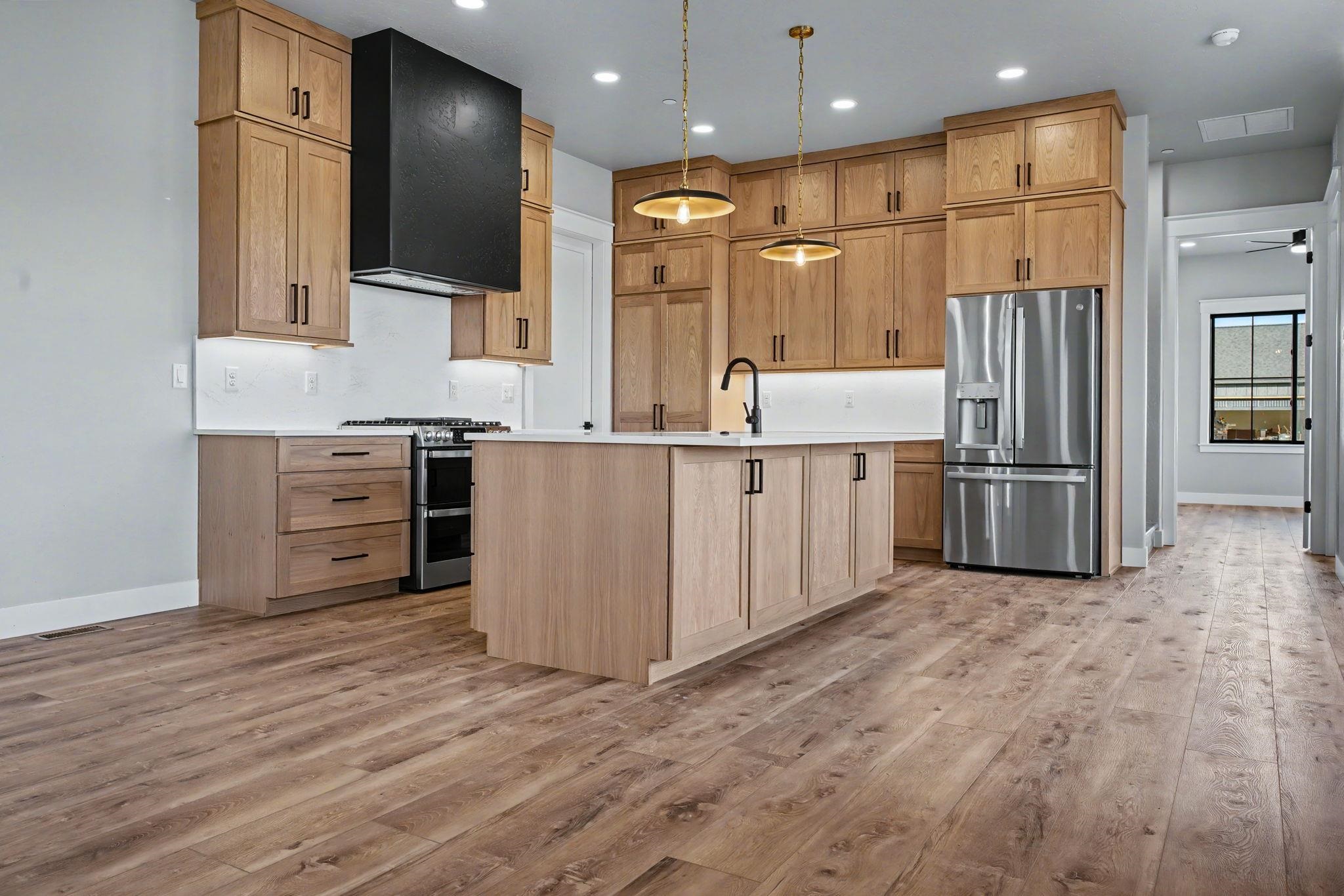 1924 K Road Fruita, CO 81521 - Photo 4 of 40 a kitchen with stainless steel appliances granite countertop a refrigerator and a stove top oven