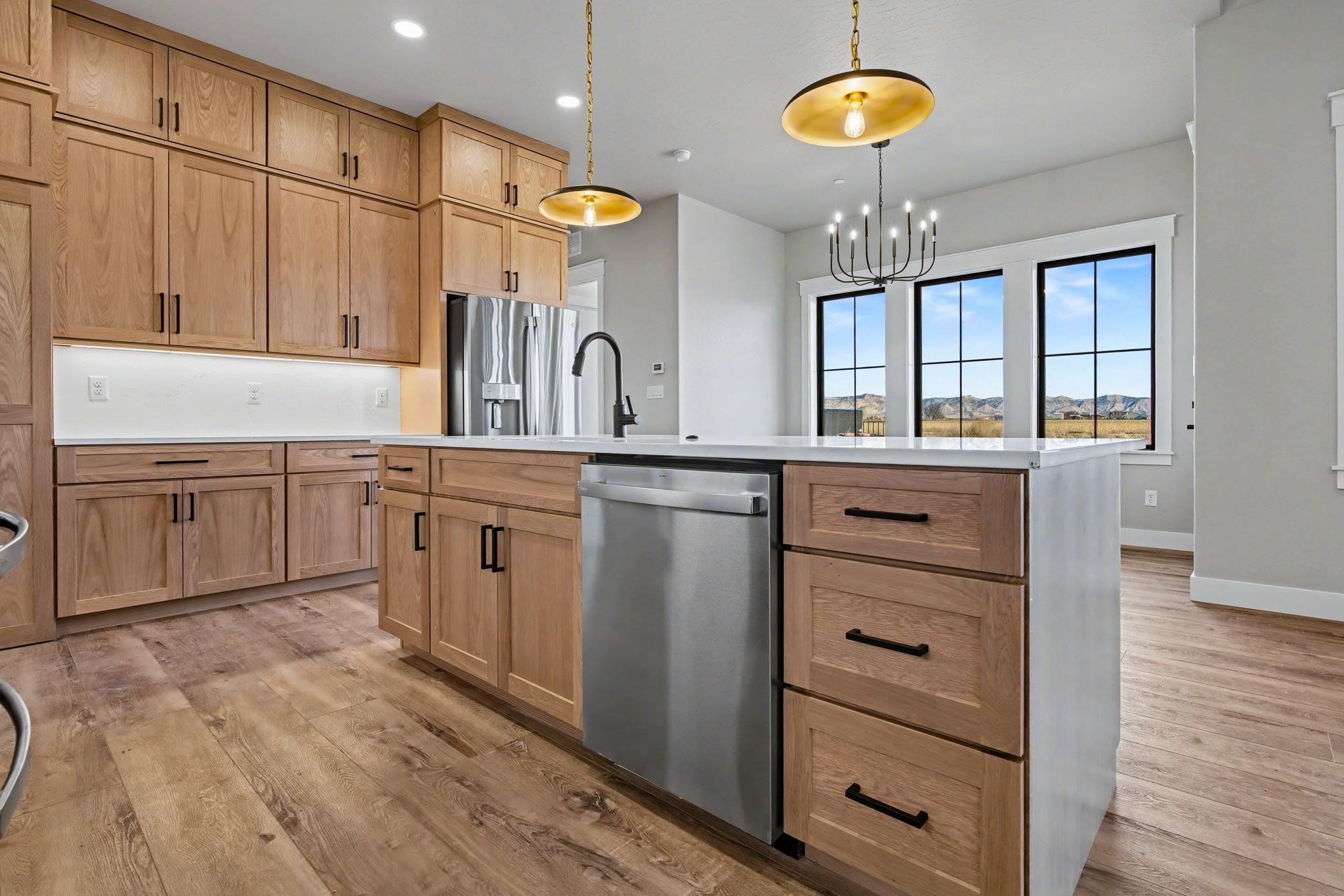 1924 K Road Fruita, CO 81521 - Photo 5 of 40 a kitchen with stainless steel appliances granite countertop a sink cabinets and wooden floor
