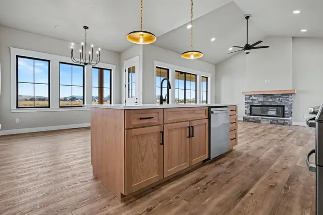 a kitchen that has a lot of cabinets and wooden floor