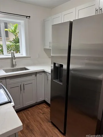 a kitchen with a sink a refrigerator and window