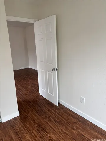 an empty room with wooden floor