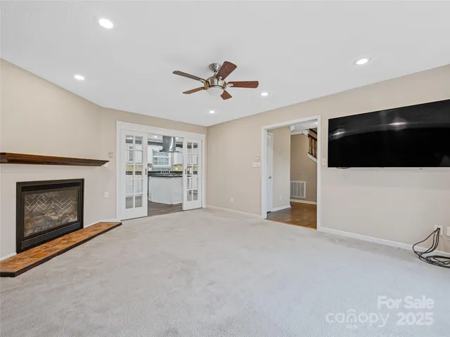 a kitchen with stainless steel appliances granite countertop a stove a refrigerator and a sink with wooden cabinets