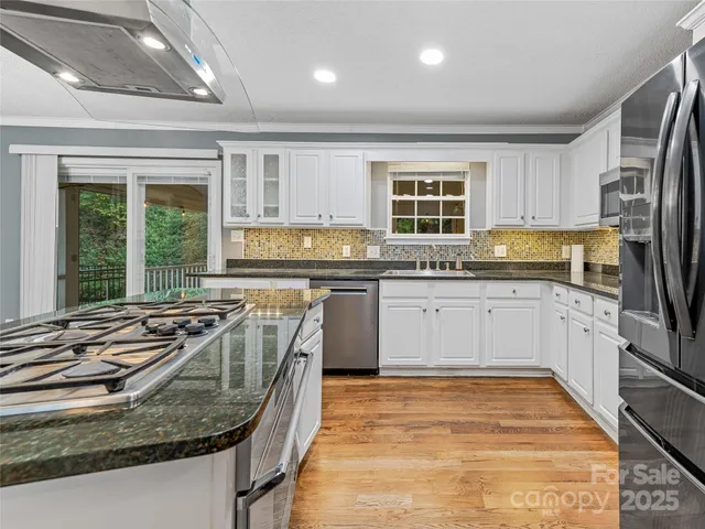 a kitchen with kitchen island granite countertop lots of counter top space and appliances