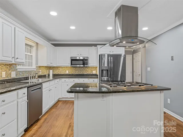 a kitchen with stainless steel appliances granite countertop a stove and a sink