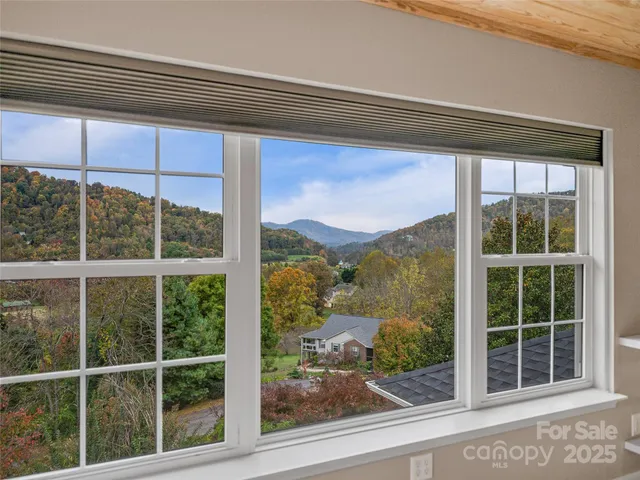 a view of a room with wooden floor and window