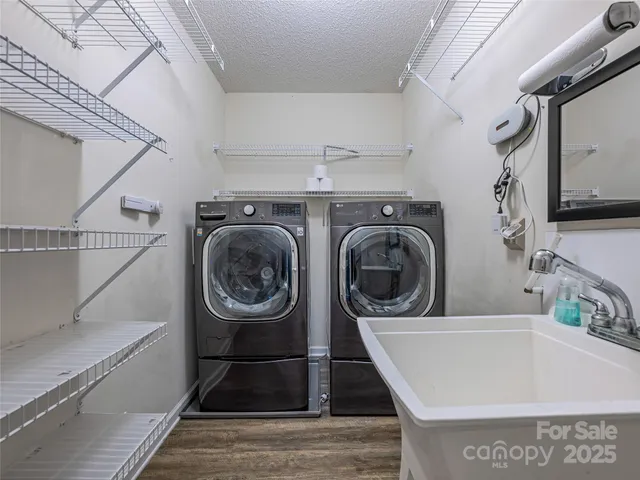 a front view of a house with a yard and mountain view in back
