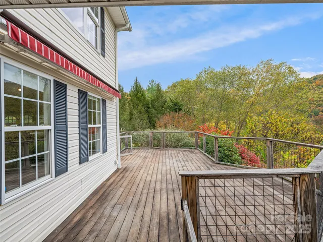 a view of a balcony with wooden floor and city view