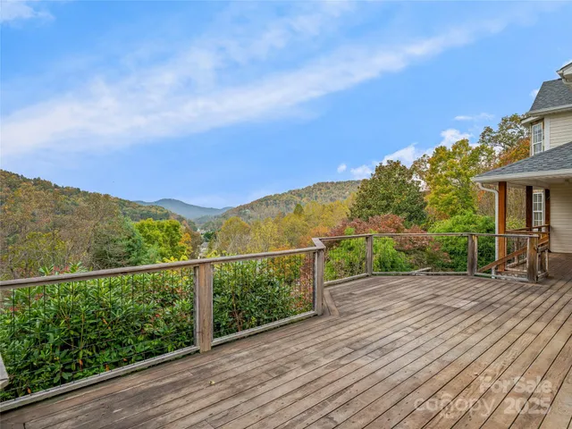a view of a balcony with wooden floor and city view