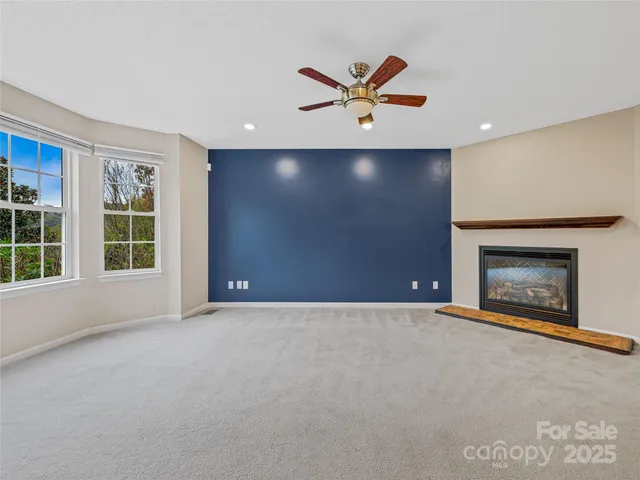 a view of an empty room with a fireplace