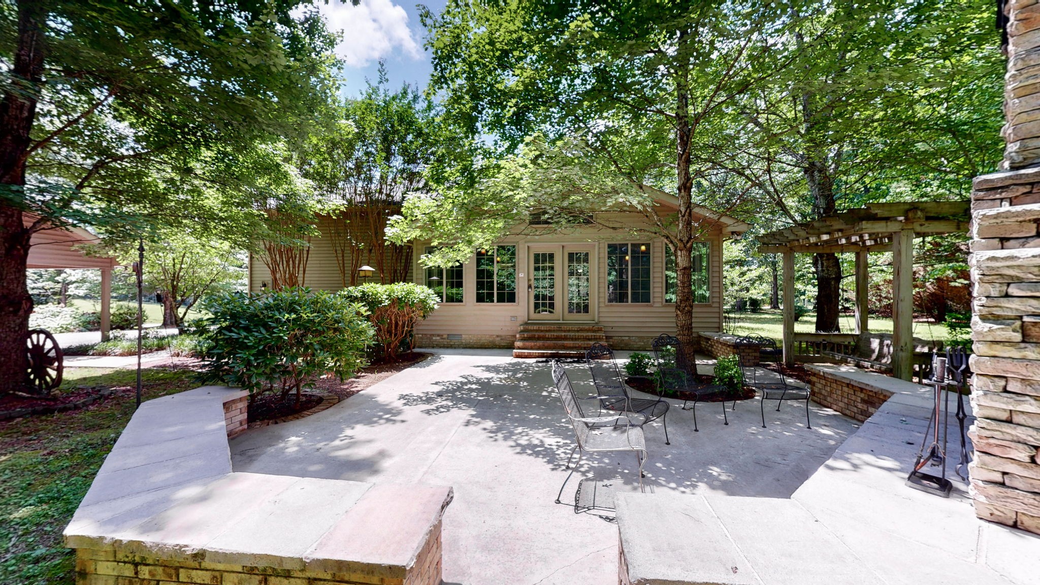 830 Motlow College Road Normandy, TN 37360 - Photo 11 of 70 a view of a patio with table and chairs potted plants and large tree