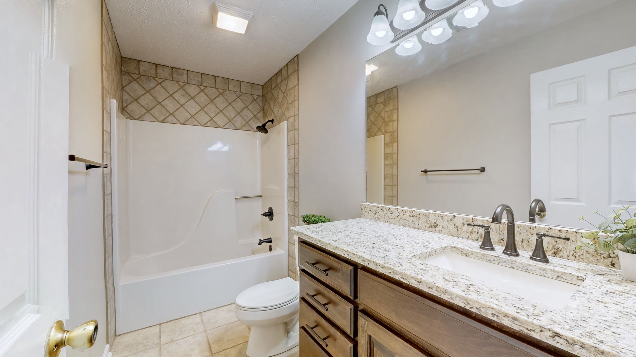 830 Motlow College Road Normandy, TN 37360 - Photo 55 of 70 a bathroom with a granite countertop sink a toilet a mirror a bathtub and shower