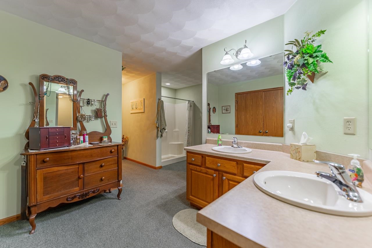 10023 Auburn Road Winnebago, IL 61088 - Photo 11 of 59 a bathroom with a sink and a mirror