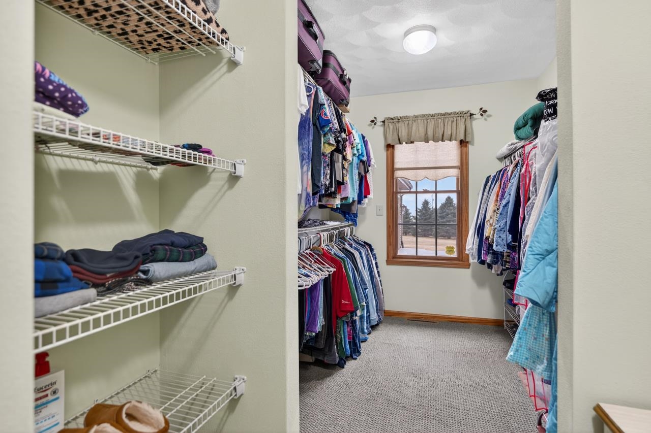 10023 Auburn Road Winnebago, IL 61088 - Photo 13 of 59 a view of walk in closet with clothes and shoes