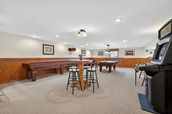 a living room with furniture and pool table