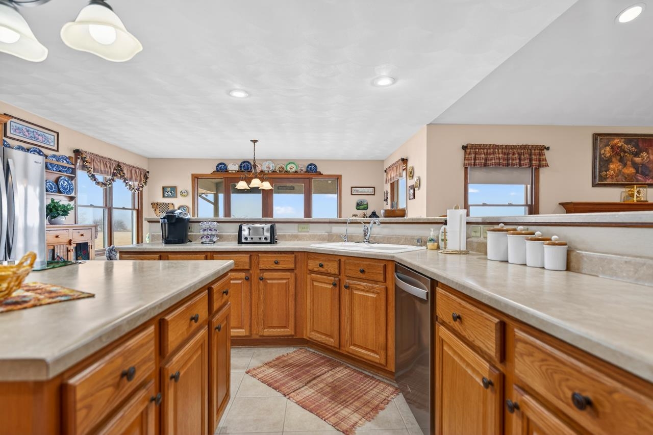 10023 Auburn Road Winnebago, IL 61088 - Photo 2 of 59 a large kitchen with stainless steel appliances granite countertop a sink and dishwasher next to a large window