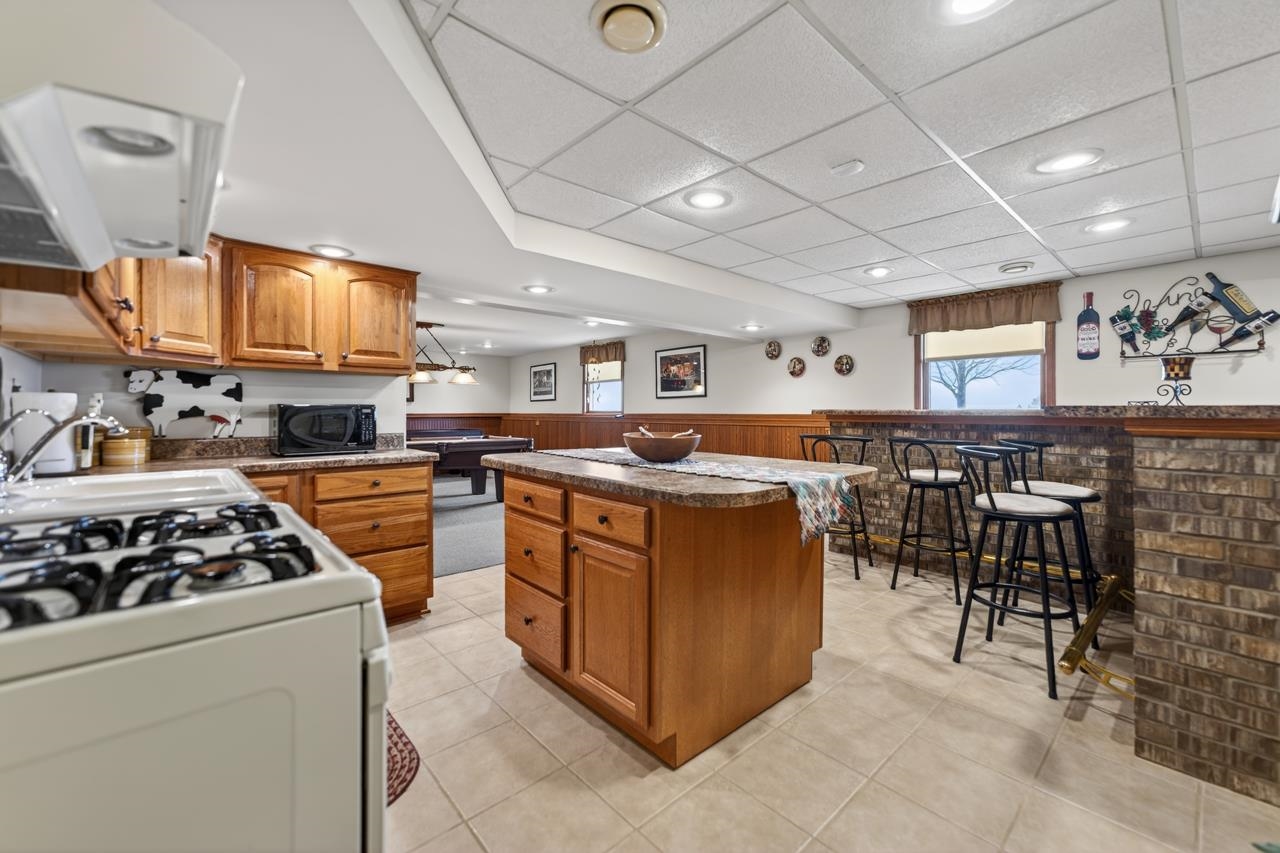 10023 Auburn Road Winnebago, IL 61088 - Photo 25 of 59 a kitchen with stainless steel appliances granite countertop a stove and a refrigerator