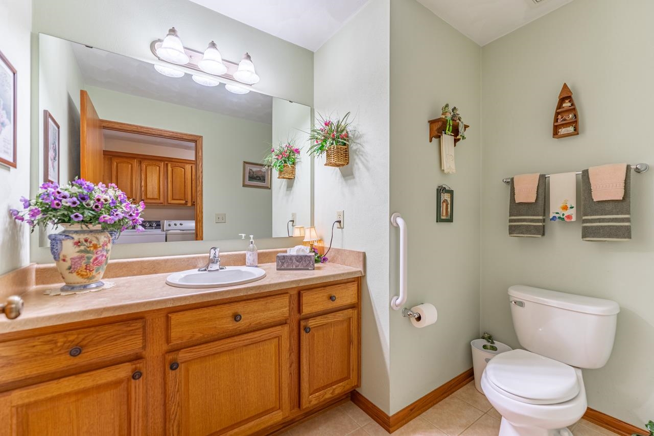 10023 Auburn Road Winnebago, IL 61088 - Photo 7 of 59 a bathroom with a granite countertop sink a toilet and a mirror