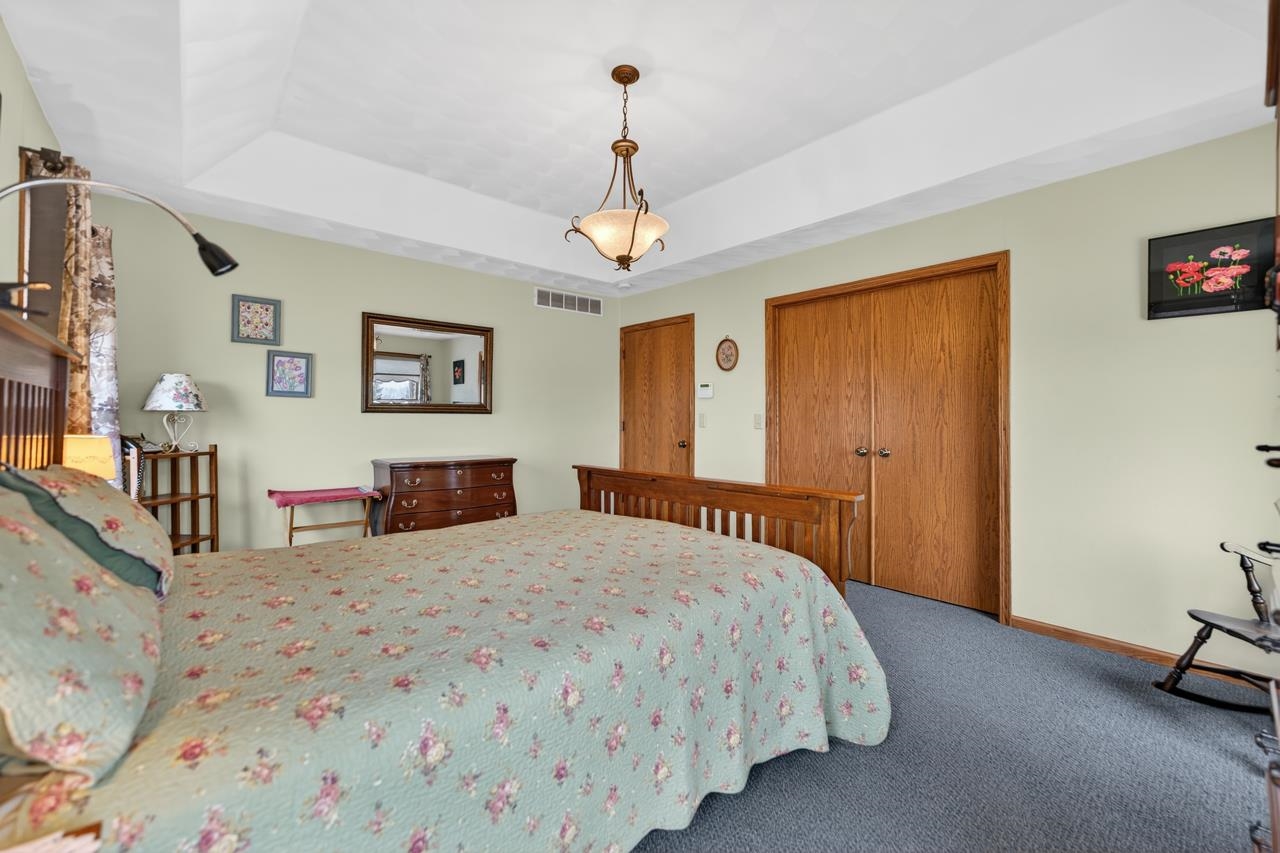 10023 Auburn Road Winnebago, IL 61088 - Photo 9 of 59 a bedroom with a bed wooden floor and window