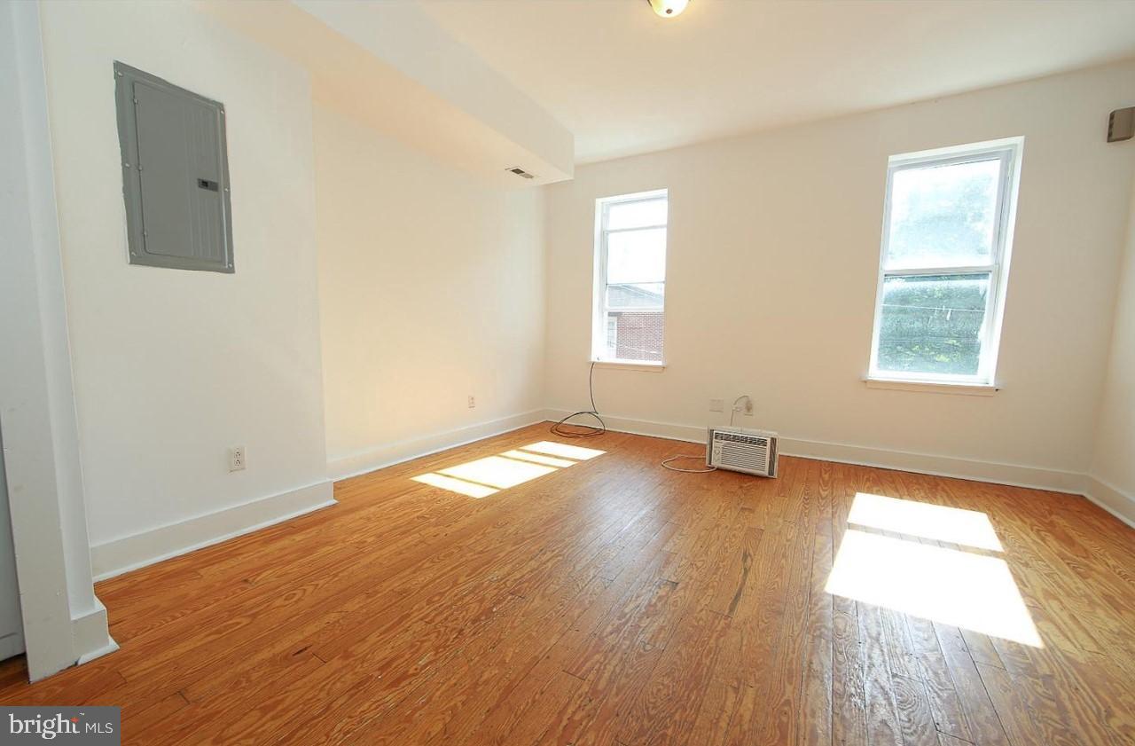 2018 North 18th Street, Unit B Philadelphia, PA 19121 - Photo 5 of 16 an empty room with wooden floor and windows