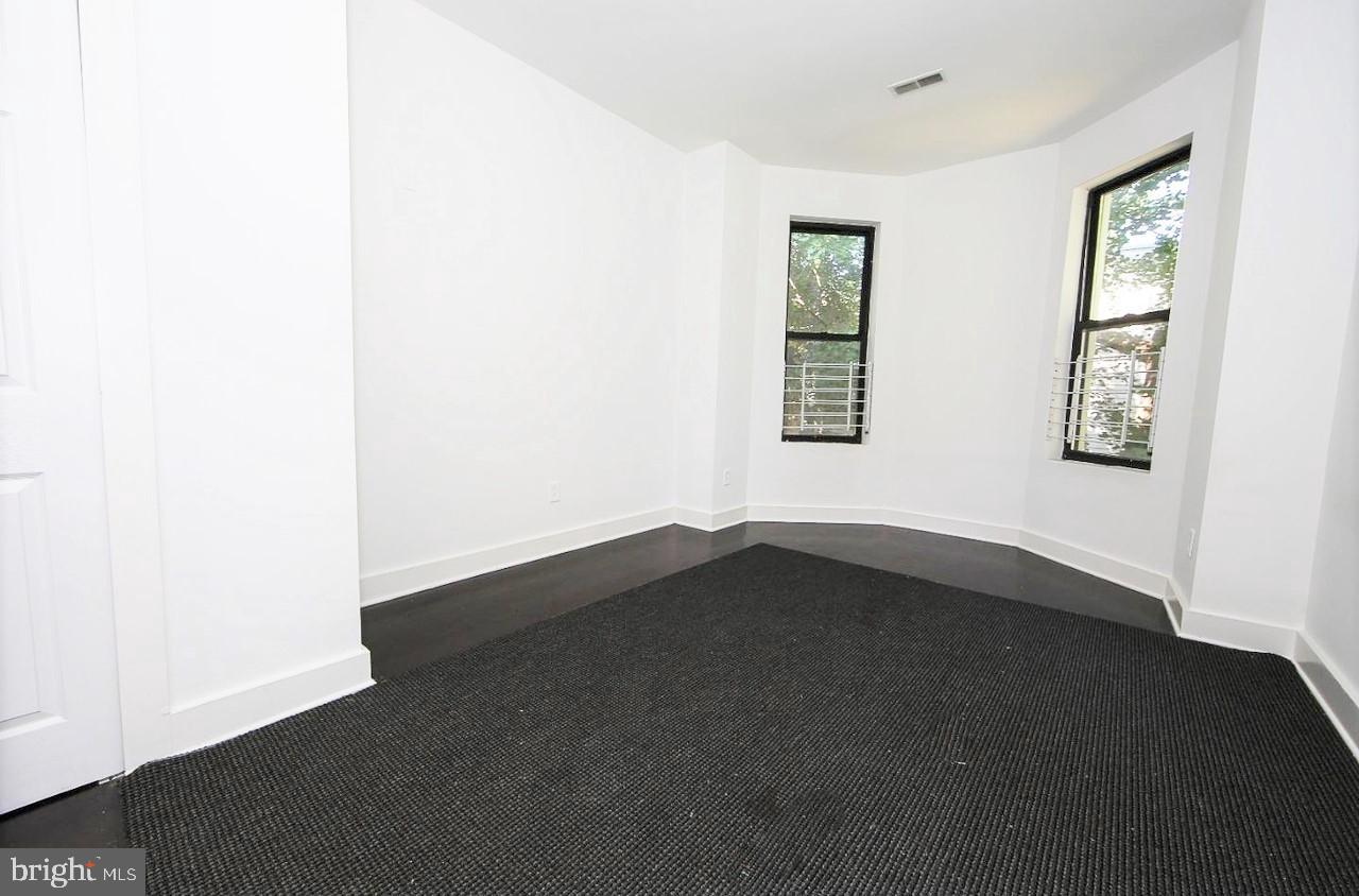 2018 North 18th Street, Unit B Philadelphia, PA 19121 - Photo 8 of 16 an empty room with wooden floor and windows