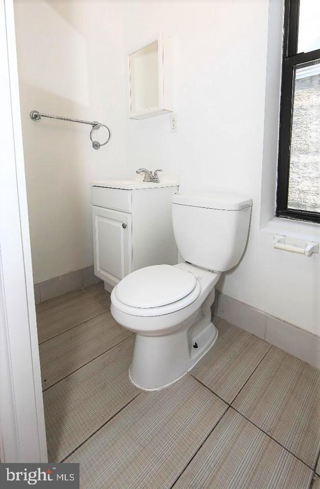 2018 North 18th Street, Unit B Philadelphia, PA 19121 - Photo 10 of 16 a white toilet sitting next to a bathroom sink and a window