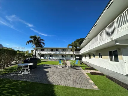 a view of a house with swimming pool and sitting area
