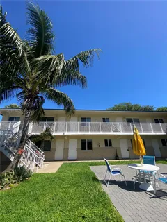a view of a house with a yard and sitting area