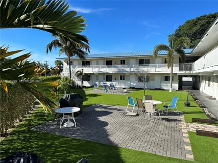 a view of a house with a yard porch and sitting area