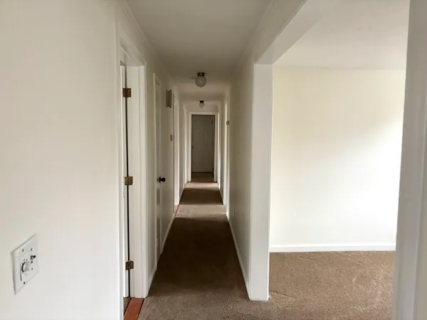 a view of a hallway with a white door