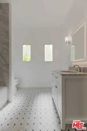 a bathroom with a sink a toilet and a shower