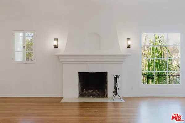 a living room with a fireplace and a wooden floor
