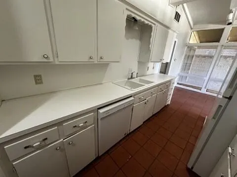 a kitchen with sink cabinets and window